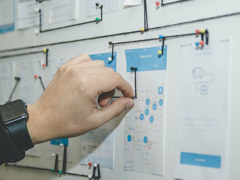 In Demand UX Design Trends for 2022: The Future of User Experience 1 A UX designer planning how each features interact with each other by incorporating current UX design trends.